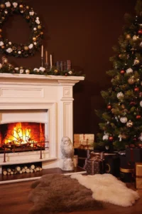Cozy Christmas living room with glowing fireplace, decorated tree, wreath, and wrapped gifts.