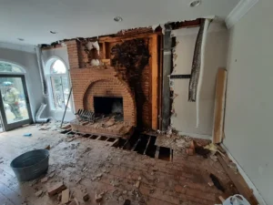 Close-up of a damaged masonry chimney highlighting cracks and deterioration signs