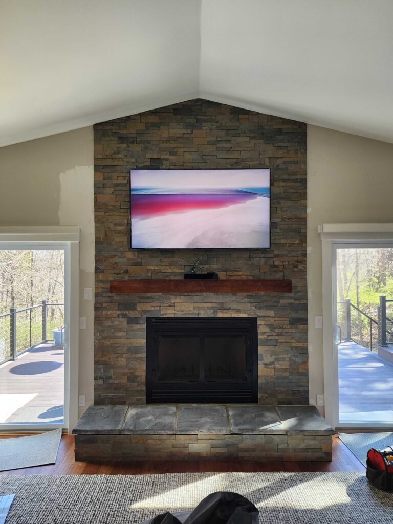 Living room fireplace with TV above mantel in Cincinnati home