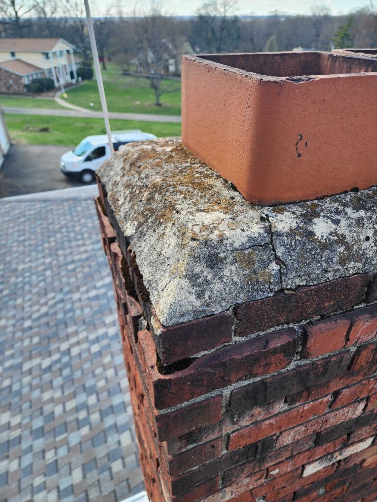 Chimney crown and cap close-up during Level 2 inspection
