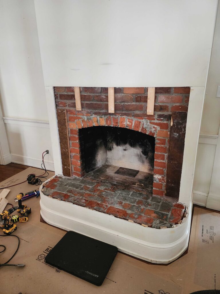 Traditional brick fireplace before wood-to-gas conversion