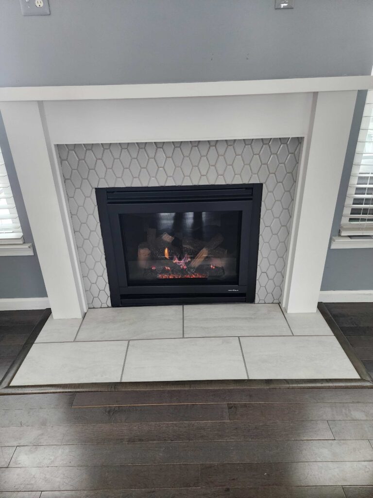 Modern gas fireplace insert installed in white surround after conversion