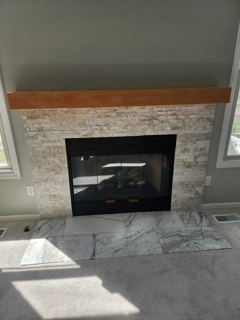 Fireplace insert with dark staining indicating repair needs