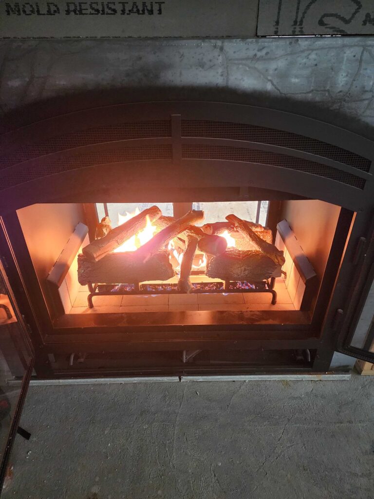 Close-up of gas fireplace flames and ceramic logs